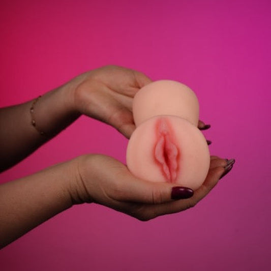 Double Surprise – Mouth and Vagina Stroker on a pink studio backdrop