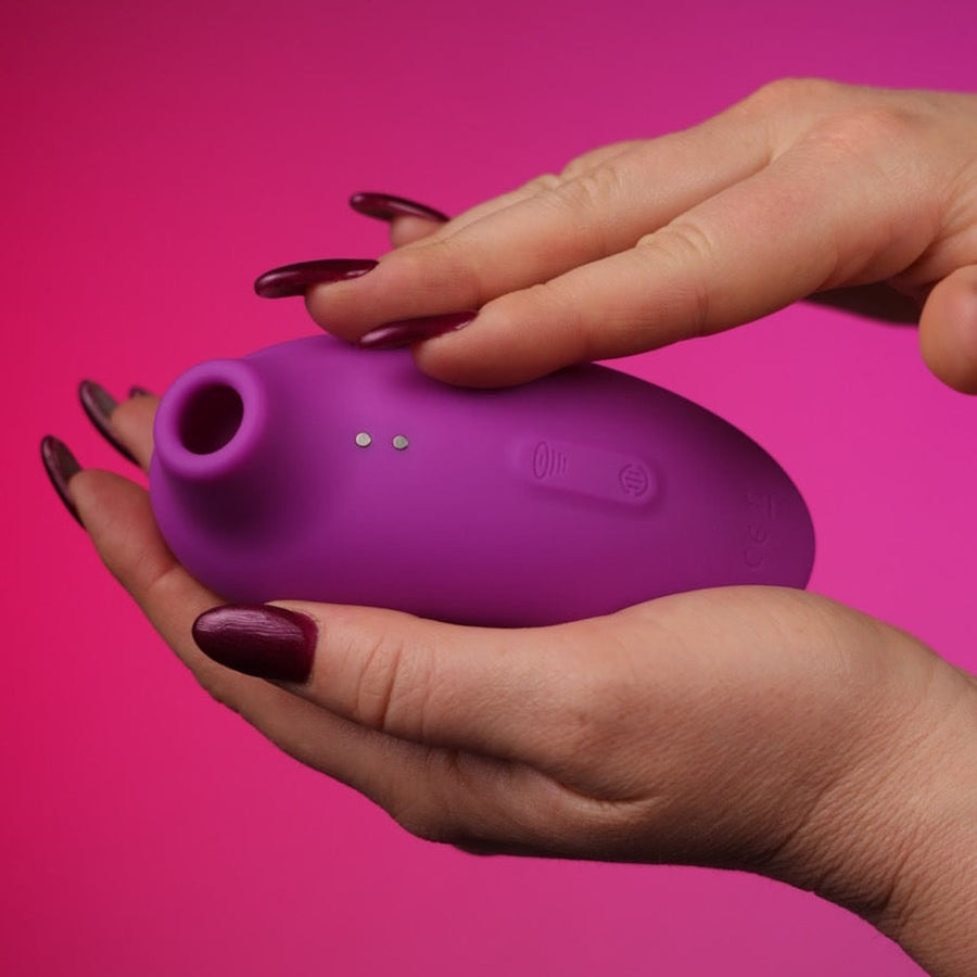 Suction Vibrator – Clitoral Air-Pulse Toy on a pink studio backdrop